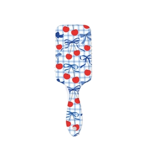 Cute cherry and bow pattern hair brush with blue checkered design on a plastic frame