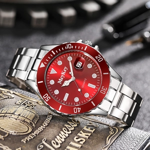 Detail of red sunburst dial and magnifying date window on silver quartz diver watch
