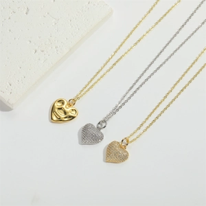 Close-up of heart pendants showing polished gold and pavé crystal finish details