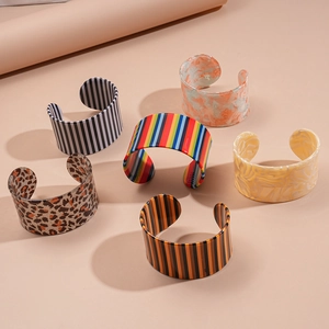 Collection of wide open C-shape resin bangles with leopard and marble striped patterns