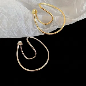 Minimalist double-layered irregular gold and silver ear cuffs with heart detail