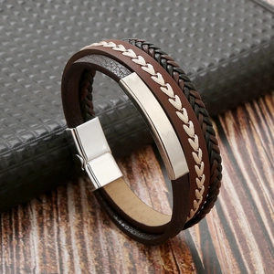 Detailed macro view of multilayer braided leather bracelet with silver metal plate