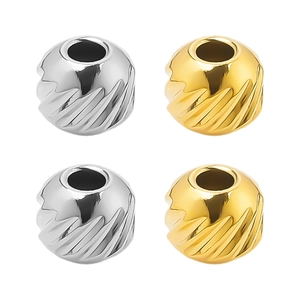 Detail of 304 stainless steel beads with diagonal textures in gold and silver finishes