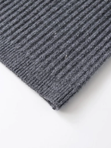 Detailed macro view of the grey ribbed knit fabric texture with soft wool-like finish