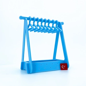 Detail of light blue acrylic mini hanger rack with small clothes hangers for jewelry storage