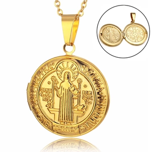 Detailed macro view of the openable gold St. Benedict locket with religious engravings