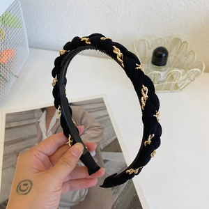 Detail of black braided headband with gold metal chain and anti-slip teeth