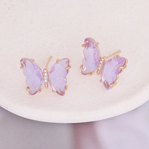 Macro shot of purple butterfly earrings with rose gold frame and micro-set cubic zirconia