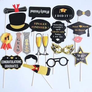 18-piece graduation photo booth props with gold foil caps, masks, and glasses on sticks