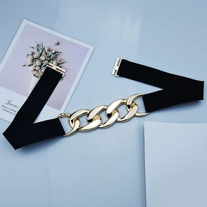 Women's black elastic corset belt with a bold gold chain link buckle for coats