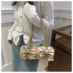 Detail of apricot cylindrical shoulder bag with double 3D bows and smooth PU leather