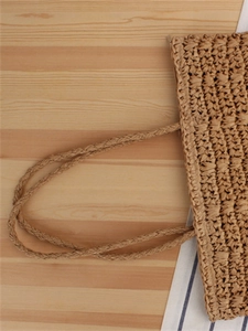 Vertical vintage woven paper rope tote bag with natural straw texture and braided handles