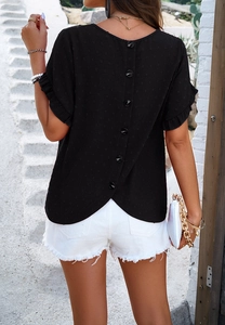 Detail of black polka dot top featuring elegant back button row and ruffled sleeves