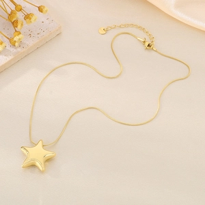 Detail of gold hollow star pendant on snake chain with adjustable lobster clasp