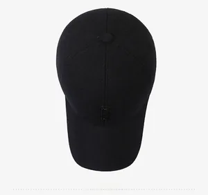 Top view detail of a black winter baseball cap featuring premium wool fabric and stitching