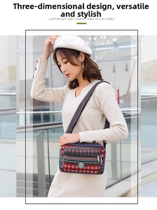 Ethnic style crossbody bag with colorful geometric patterns and adjustable strap worn by model