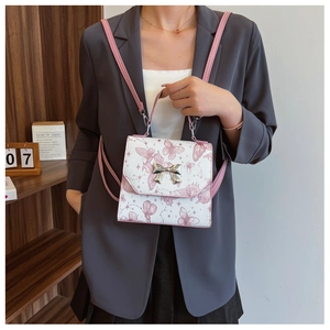 White leather backpack with pink butterfly prints and a silver metal bow buckle detail