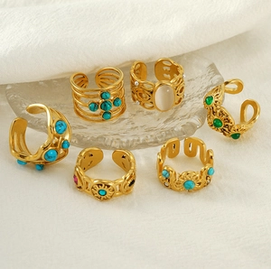 Detail of vintage 18k gold plated stainless steel rings set with malachite stones