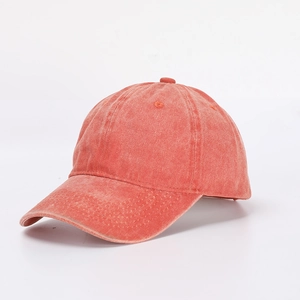 Side view of vintage washed coral red cotton twill baseball cap with six-panel structure