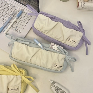 Close-up of pastel blue and purple pencil cases with embroidered SOZAKKA labels and soft texture