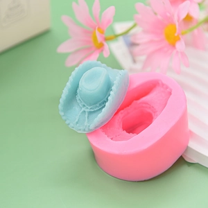 Pink silicone cowboy hat mold with blue textured clay hat on a decorative tray