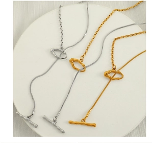 Detail of mixed snake and cable chain necklace with gold and silver toggle clasp