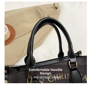 Close-up of comfortable leather handle and gold hardware on Santa print tote bag