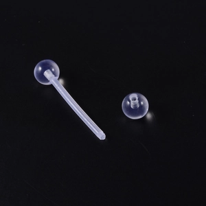 Transparent acrylic tongue ring with straight bar and balls on solid black background