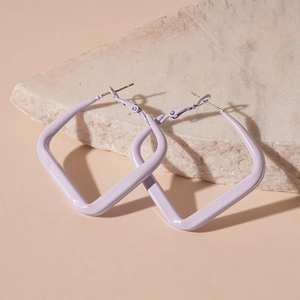 Detail of light purple square geometric hoop earrings on natural stone surface