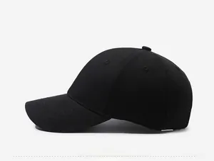 Side view detail of a classic black cotton twill baseball cap with curved brim and panels