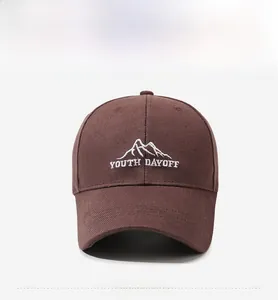 Close-up of white mountain embroidery and Youth Dayoff text on dark brown baseball cap