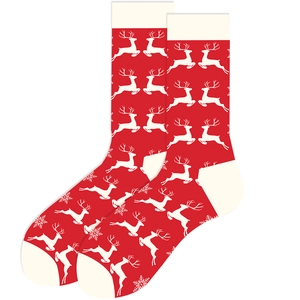 Detailed view of festive red Christmas socks with white reindeer and snowflake patterns