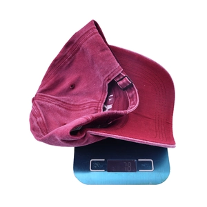 Vintage washed burgundy baseball cap with mama embroidery on a scale showing 78g weight