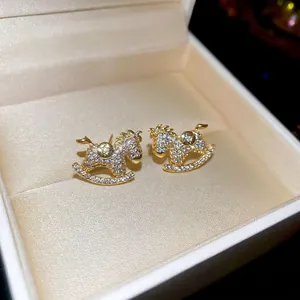 Cute rocking horse stud earrings featuring sparkling cubic zirconia in gold plating