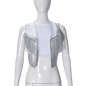 Close-up of metallic silver fringe vest with sparkling sequin trim and long tassels