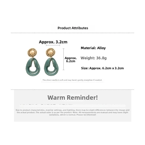 Detail view of vintage drop earrings with alloy material specs and weight info