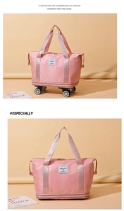 Detail of pink expandable travel bag showing detachable swivel wheels and oxford fabric