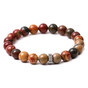 Macro detail of natural tiger eye and matte agate beads with a textured silver spacer