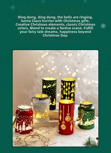Close-up of frosted glass Christmas candle holders with gold reindeer and snowflake patterns