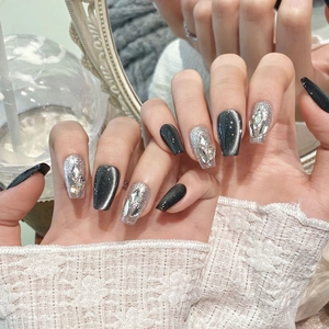 Dark grey cat eye press-on nails with silver glitter and large rhinestones in coffin shape