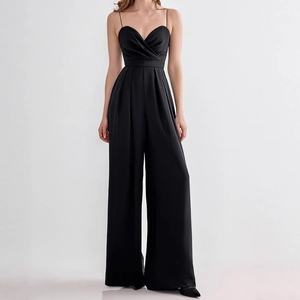 Detail of elegant black V-neck jumpsuit with waist pleats and wide-leg cut texture