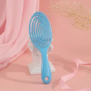 Detail view of a light blue hollow spiral hair brush for scalp massage and blow drying