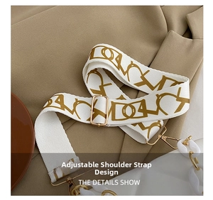 Detail of adjustable patterned strap with gold hardware on a white crossbody bag
