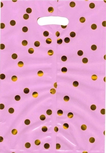 Detailed view of pink plastic gift bag with glossy gold polka dots and die-cut handle