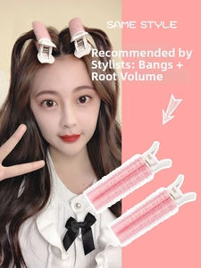 Pink velcro rollers and white root clips for volumizing bangs and styling women's hair