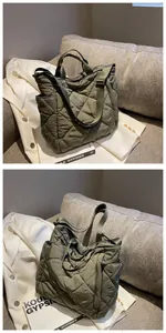 Detailed side view of quilted olive green tote bag featuring soft nylon texture and side pocket