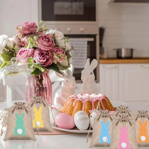 Linen Easter drawstring gift bags with colorful bunny tail prints on a festive table