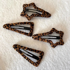 Leopard print fabric hair clips set featuring star and teardrop shapes on white background