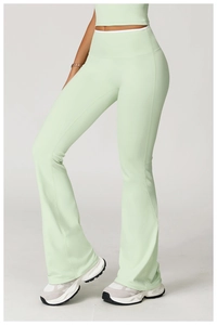 Detail of high-waist flared yoga pants in mint green with white contrast waistband
