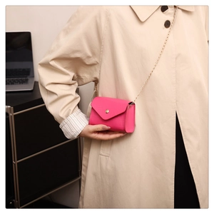 Detailed close-up of pink stone pattern PU leather crossbody bag with gold chain strap
